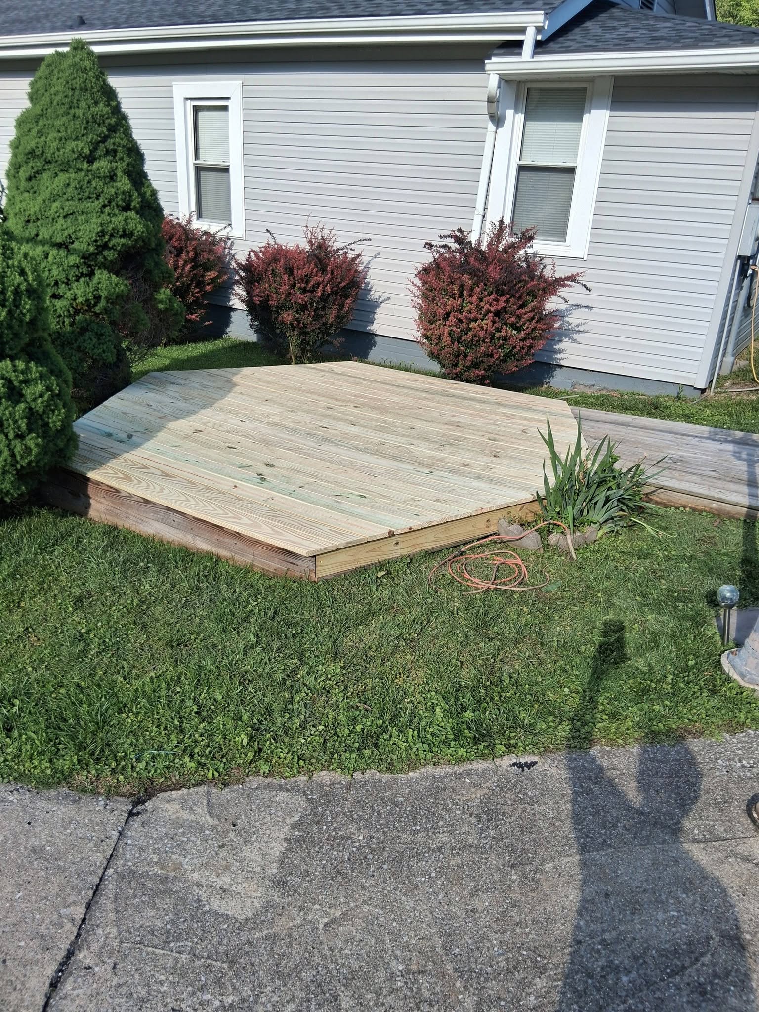 Deck with weathered gray boards replaced by new lumber